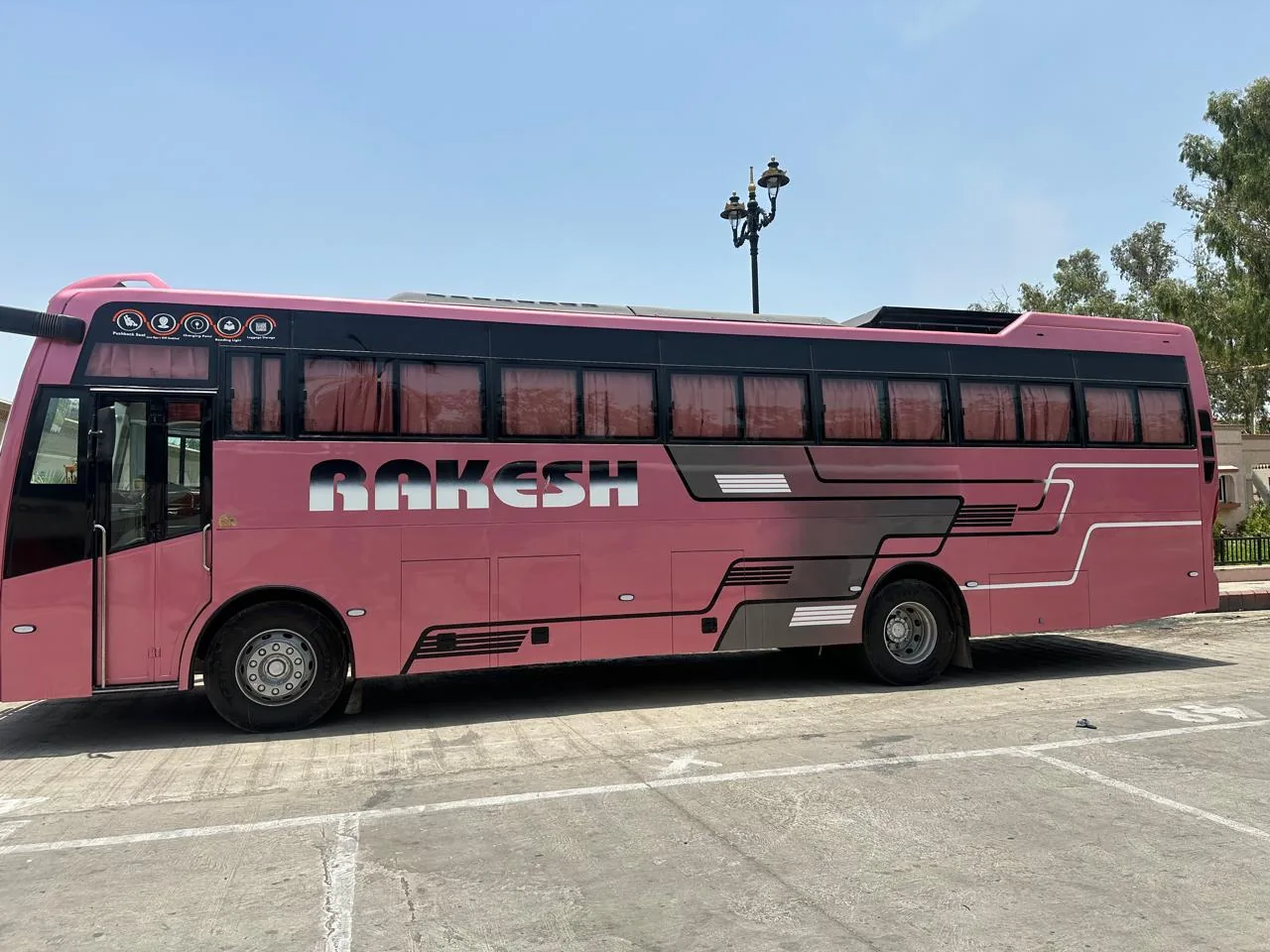 Rakesh Travels premium pink bus